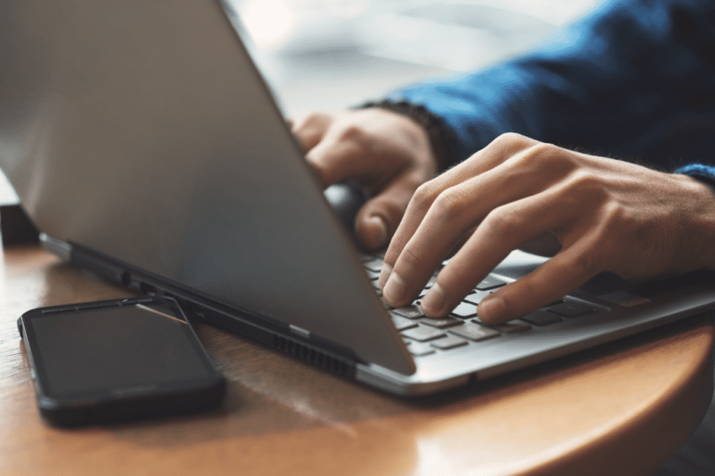 Close up shot of hands typing on laptop